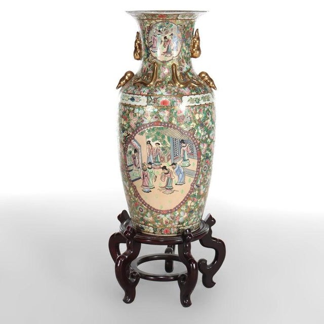 Monumental Vintage Chinese Rose Medallion Vase With Carved Hardwood Base 20thC Measures - 48 1/2" x 20" x 20" An example...