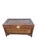 A richly decorative vintage storage chest featuring extensive carved relief work across its exterior. The chest is framed...