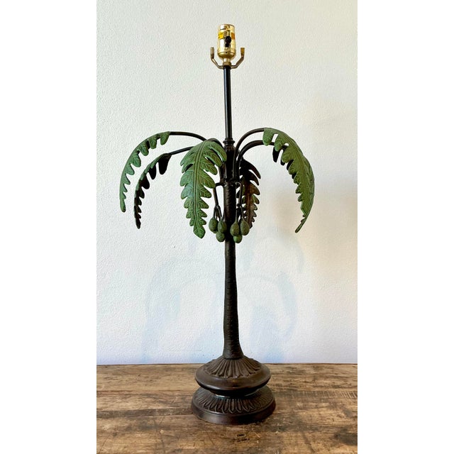 This exquisite vintage table lamp is a masterclass in Hollywood Regency glamour, featuring a masterfully sculpted palm...