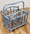 Vintage rattan magazine rack in a weathered periwinkle blue. Sturdy construction. Some unraveling to bindings as shown.
