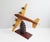 This wooden aircraft is a handmade model aircraft from the 1930s. The sculpture is built on a carved base with a 360...