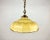 Yellow glass hanging lamp with brass fixture from the 1960s. The glass shade has a bit of the shape of an umbrella....