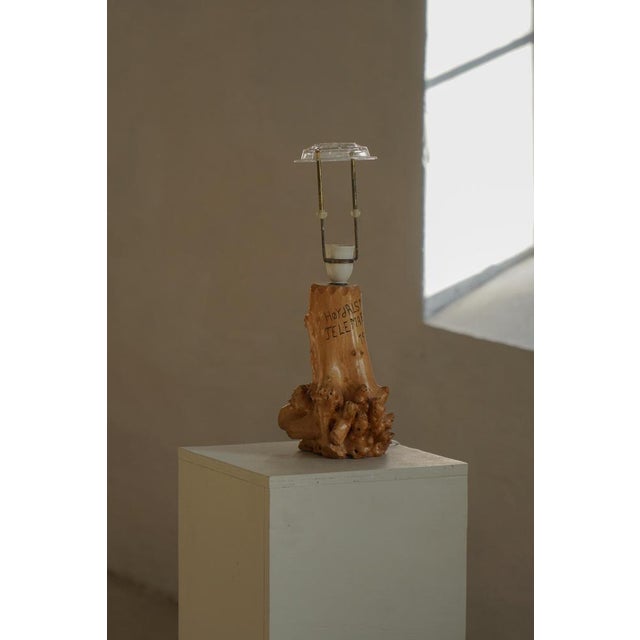 A sculptural scandinavian table lamp crafted in solid birch wood, likely made in norway in 1972. The lamp features a...