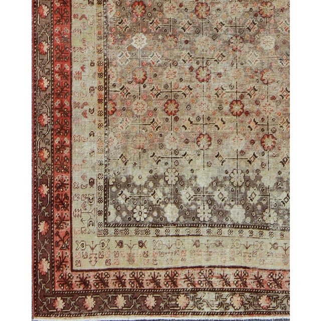 Measures: 6'3'' x 11'5''. This Central Asian Khotan rug is an antique from the early 20th century. This piece features a...