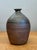 This vintage studio pottery vase is a masterclass in the Wabi-Sabi aesthetic, celebrating the inherent beauty of natural...