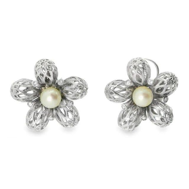14K White Gold Earrings with Diamonds. Each earring features 5 brilliant round diamonds delicately set in the center of an...