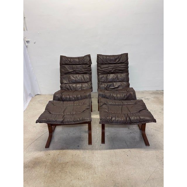 Rare pair of Ingmar Relling brown leather and wood high back Siesta chairs with footrests for Westnofa. 1960s. Separate...