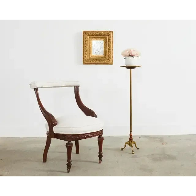 Amazing pair of early 19th century English regency cock fighting chairs crafted from mahogany. The frames have a padded...