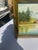 Up for consideration is a beautiful vintage gold and green framed riverside painting with colorful foliage and mountains....