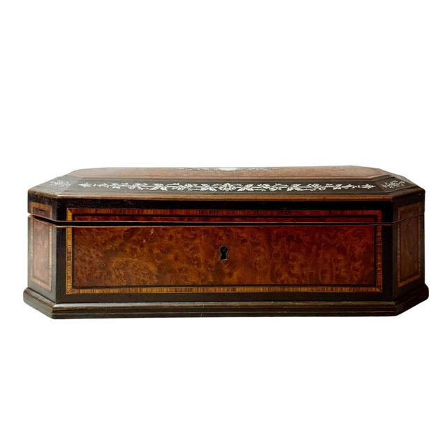A refined Napoleon III period jewelry box from 19th century France, beautifully crafted in burl wood, rosewood, ebony and...