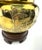 A sculptural mid-century brass table lamp featuring a richly embossed Chinoiserie landscape with pagoda, bridge, and tree...