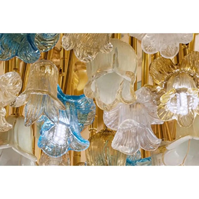 Scenographic bright flush mount with amber,white and light-blue little flowers. a composition of murano glass floreal...