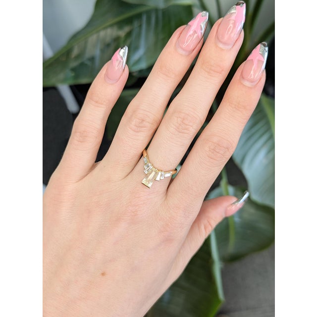 A radiant 1.4ct canary sapphire glows with warm golden hues, accented by a striking arrangement of Lab diamonds. Set in...