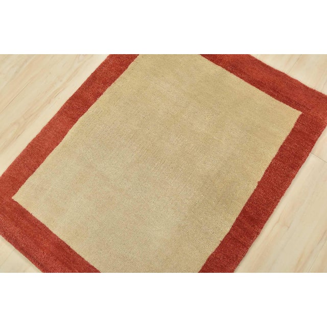 A contemporary Gabbeh rug hand-knotted with an all-wool pile on a cotton foundation. This finely woven oriental rug...