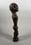 NYAMWEZI, TANZANIA. Hardwood with a brown patina and inlaid with bronze rings at the eyes and nipples. Standing male...