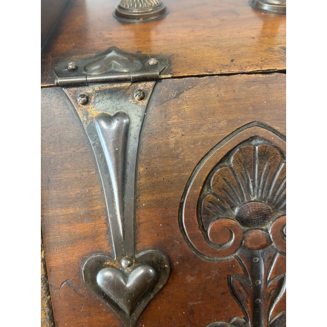 This antique English coal scuttle is a stunning example of 19th-century craftsmanship. Featuring intricate metal design...