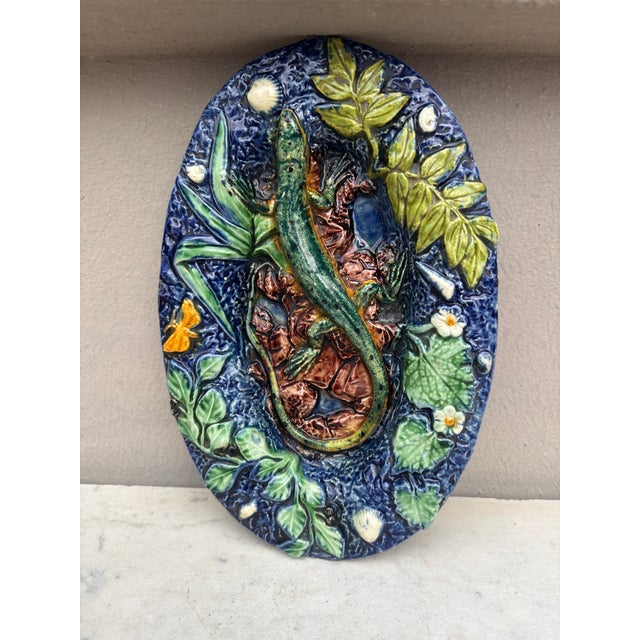 Small Palissy lizard wall platter signed Thomas-Victor Sergent, circa 1890. 8 by 5 inches. On a dark blue background the...