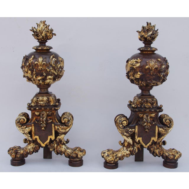 Pair of two patina bronze, brown and gold, Renaissance style firedogs standing on two lion paws. Scottie shape firedogs’s...