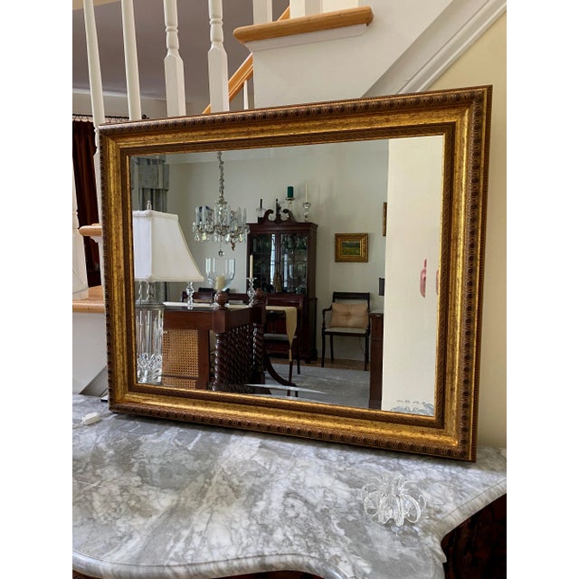This is a heavy, beveled mirror with a gold leaf, etched frame. This mirror is from the 1970’s but looks like new. This...