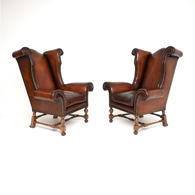 A magnificent pair of antique leather wing back armchairs. They were made in England, and they date from around the...