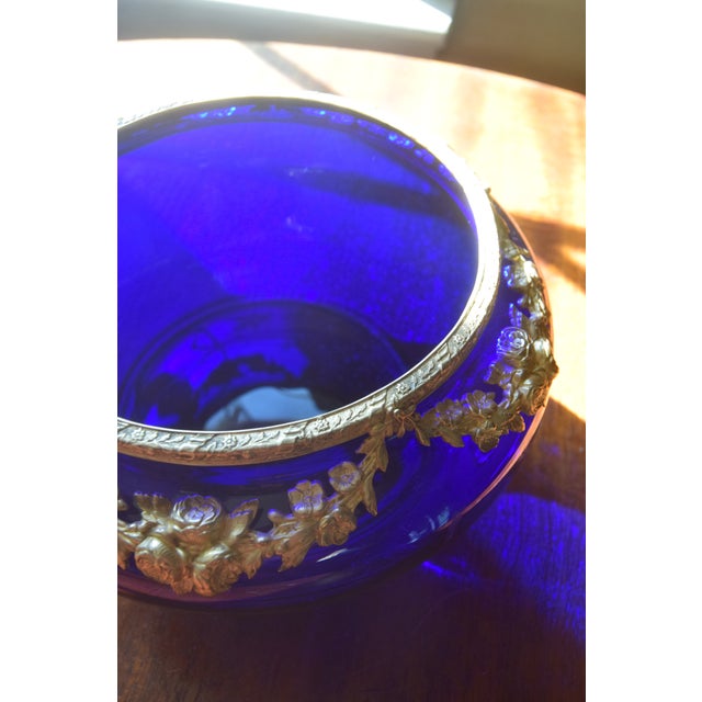 A beautiful antique French jardinière featuring a rich cobalt blue glass body adorned with finely detailed gilt bronze...