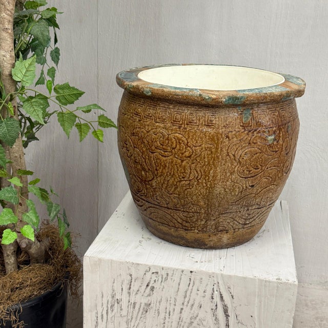 "About This Piece About This Piece This brown glazed ceramic planter carries the spirit of ancient craftsmanship and the...