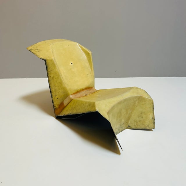 A very large lounge chair made of heavy fiberglass, 1980, with the appearance of an origami chair. The back is matte...