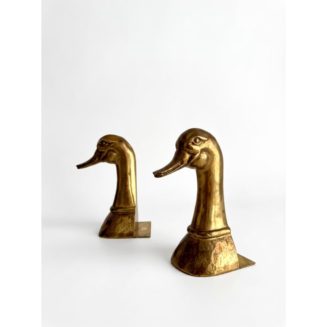 A pair of decorative figures shaped like duck heads, crafted from solid brass. Produced in Spain by Bronces Almazán during...