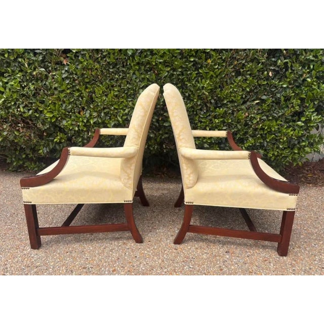 Beautiful pair of carved mahogany Martha, Washington style chairs with buttercream yellow damask upholstery. Generously...