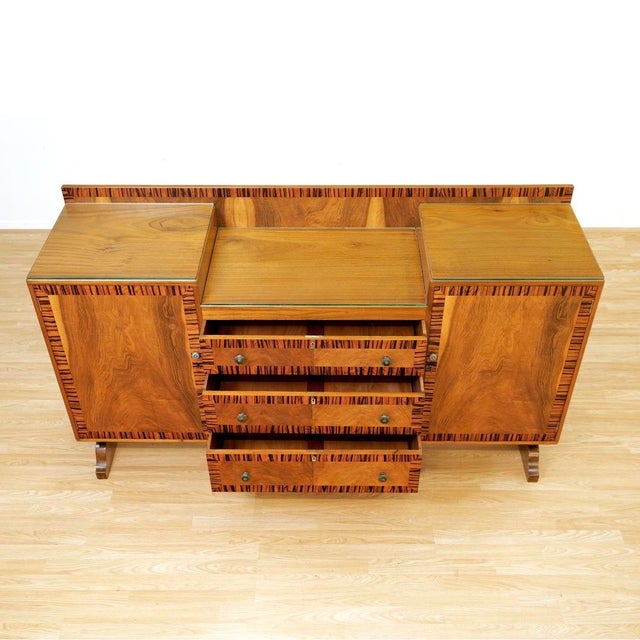 Striking and highly architectural, this vintage sideboard blends late Art Deco influence with the warmth and craftsmanship...