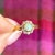 This exquisite Victorian ring, handcrafted around 1890, showcases a stunning central opal that dances with a captivating...