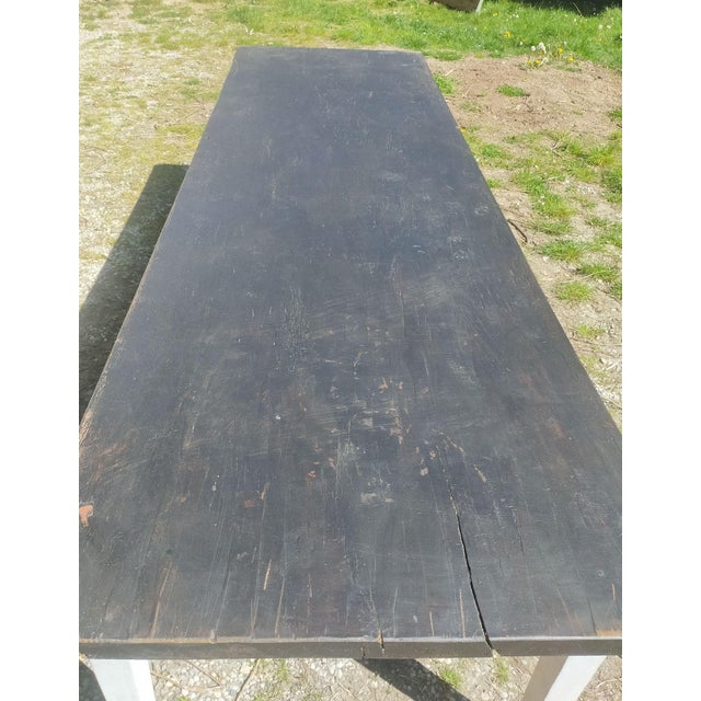 Large table, 3 meters long, with a black base and top. The top is made of elm and forms a single block.