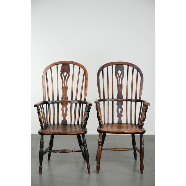 This set of 4 antique English highback Windsor dining chairs features beautiful wood carvings and a stunning patina. A...
