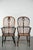 This set of 4 antique English highback Windsor dining chairs features beautiful wood carvings and a stunning patina. A...