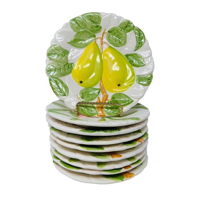 A charming and expansive set of nine hand-painted, embossed ceramic salad or dessert plates from the "Fruit Du Jour"...