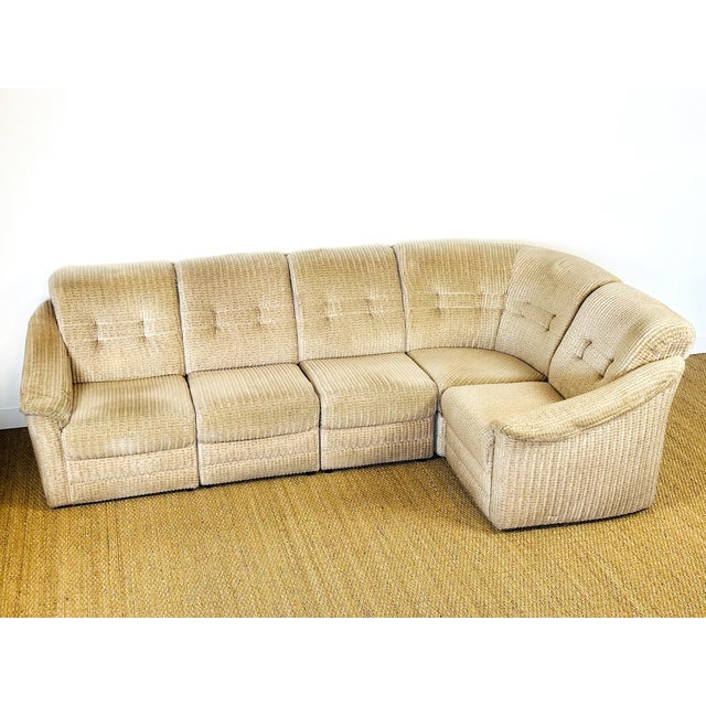 Modular corner sofa in beige corduroy fabric (chenille velvet style) dating from the 1960s, featuring a retro design and...