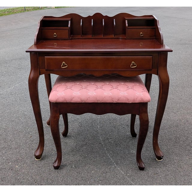 This vintage solid mahogany secretary desk with a matching stool offers a masterclass in small-space luxury and timeless...