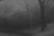 The artwork presents a monochromatic landscape, where bare trees with intricate, textured branches rise against a softly...