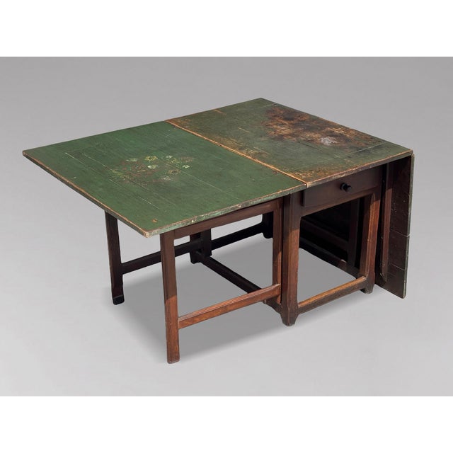 A Charming Early 19th Century Swedish Painted Pine Slagbord Drop-Leaf Dining Table, Sweden, circa 1820 This delightful...