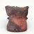 A petite pit-fired studio pottery vase of slightly twisted form in earthy tones of terracotta and ash. Two little arms...