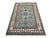 This Kazak-style wool area rug features a soft blue-gray field with bold red medallions and smaller geometric tribal...