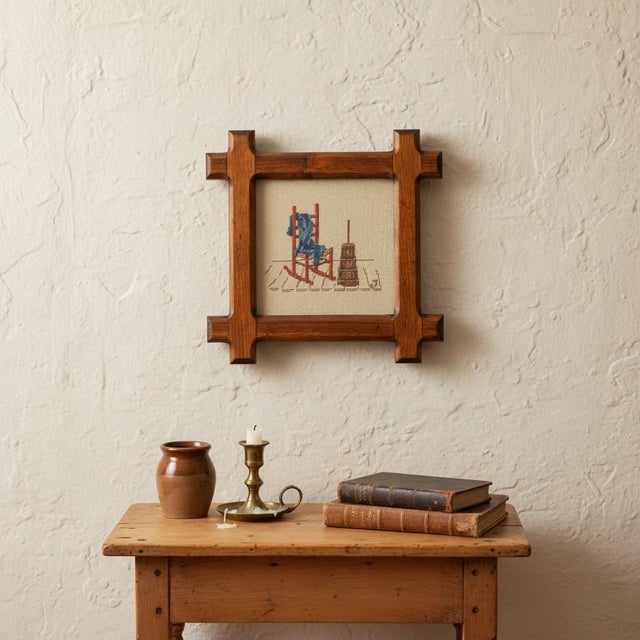 Vintage 1982 hand-worked cross stitch featuring an old-fashioned rocking chair and butter churn, signed “AG 1982.” Worked...