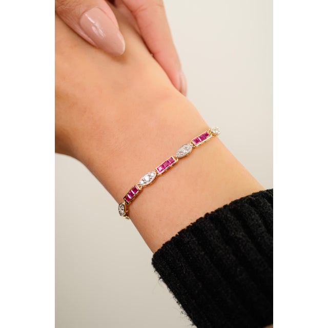 This elegant tennis bracelet features square cut natural rubies totaling 3.76 carats, set in 14k yellow gold. each ruby...