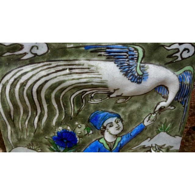 Deep avocado green, cobalt blue, and white are the bold pigments of this royal hunter on a lively horse feeding a mythical...