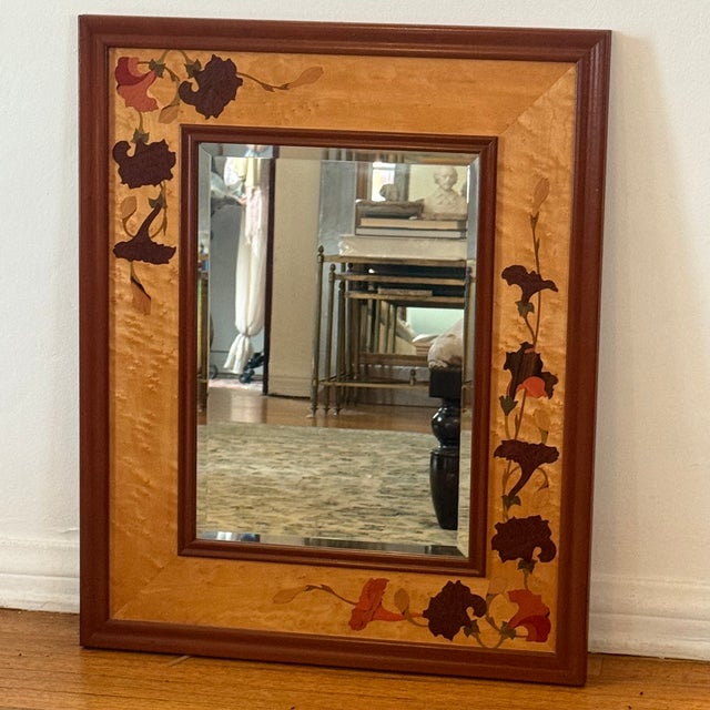 A Hudson River Inlay wood mirror featuring ginkgo leaf marquetry and warm-toned decorative inlay. Measures approx: 25.5W x...