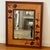 A Hudson River Inlay wood mirror featuring ginkgo leaf marquetry and warm-toned decorative inlay. Measures approx: 25.5W x...