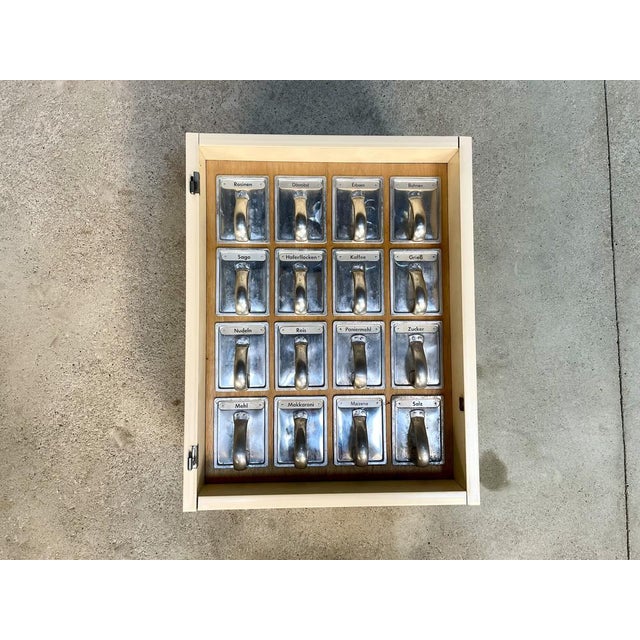 This authentic German kitchen wall cabinet features a set of 16 iconic kitchen-chutes from the so-called 'Frankfurter...