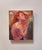 The artwork depicts a striking figure of a woman with flowing red hair, her posture exuding a sense of confidence and...