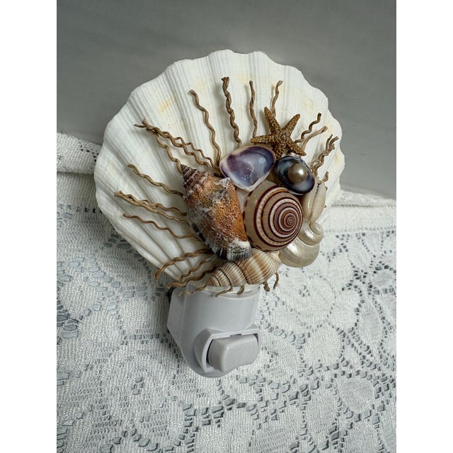 Handcrafted seashell nightlight with assorted shells, small starfish and pearl accents. Fun for any room, beach decor, or...