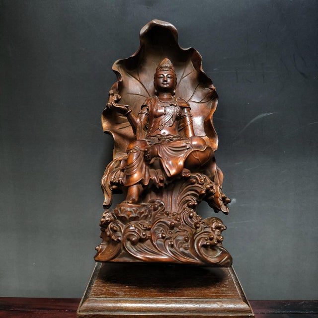 Elevate your meditation space or gallery wall with this exquisite hand-carved wooden sculpture of Guan Yin, the...